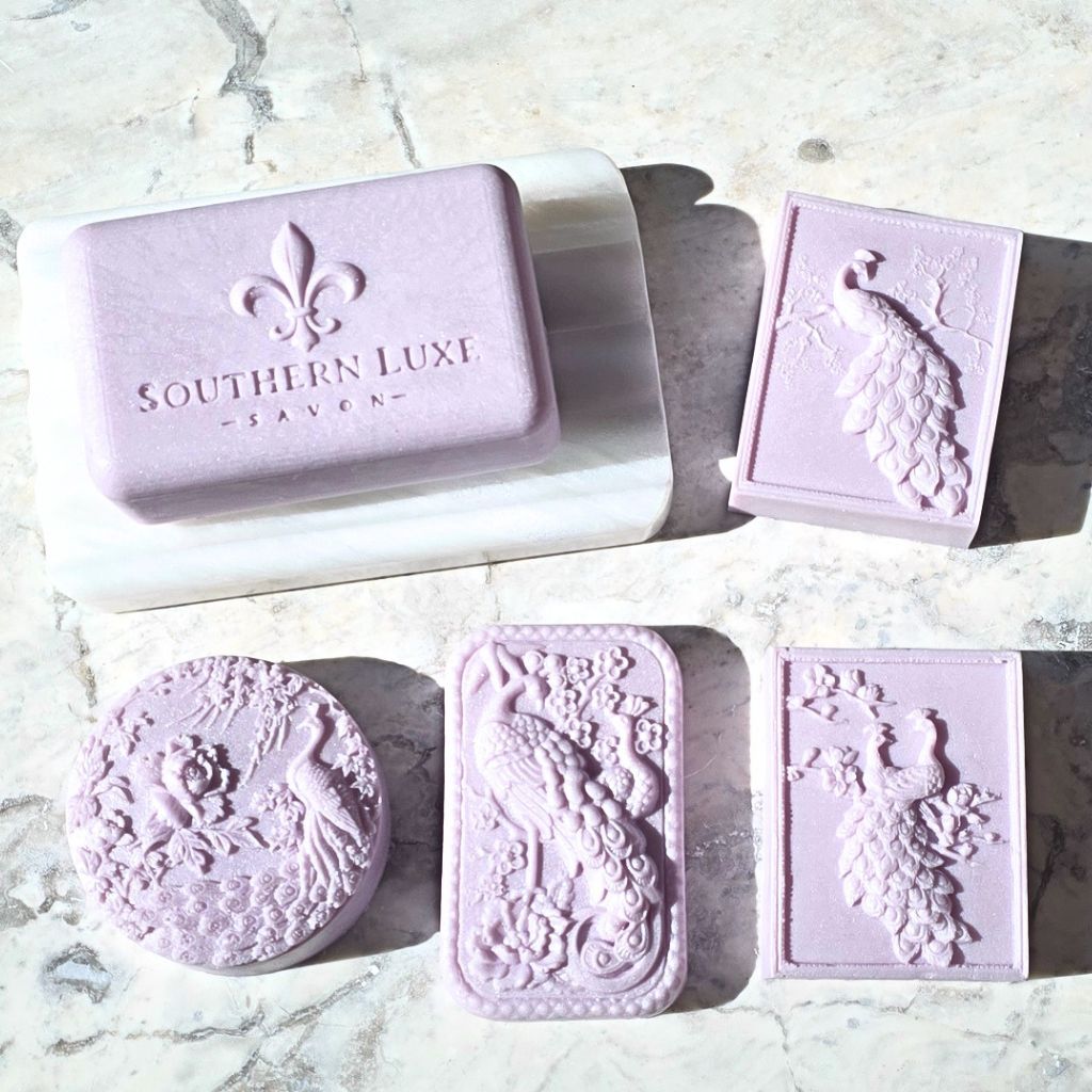 Set of lavender soap bars with decorative designs on a marble surface, featuring 'Southern Luxe' branding