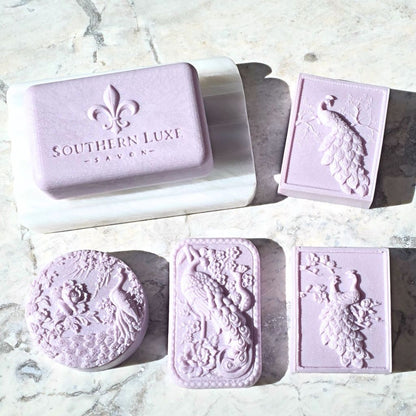 Set of lavender soap bars with decorative designs on a marble surface, featuring 'Southern Luxe' branding