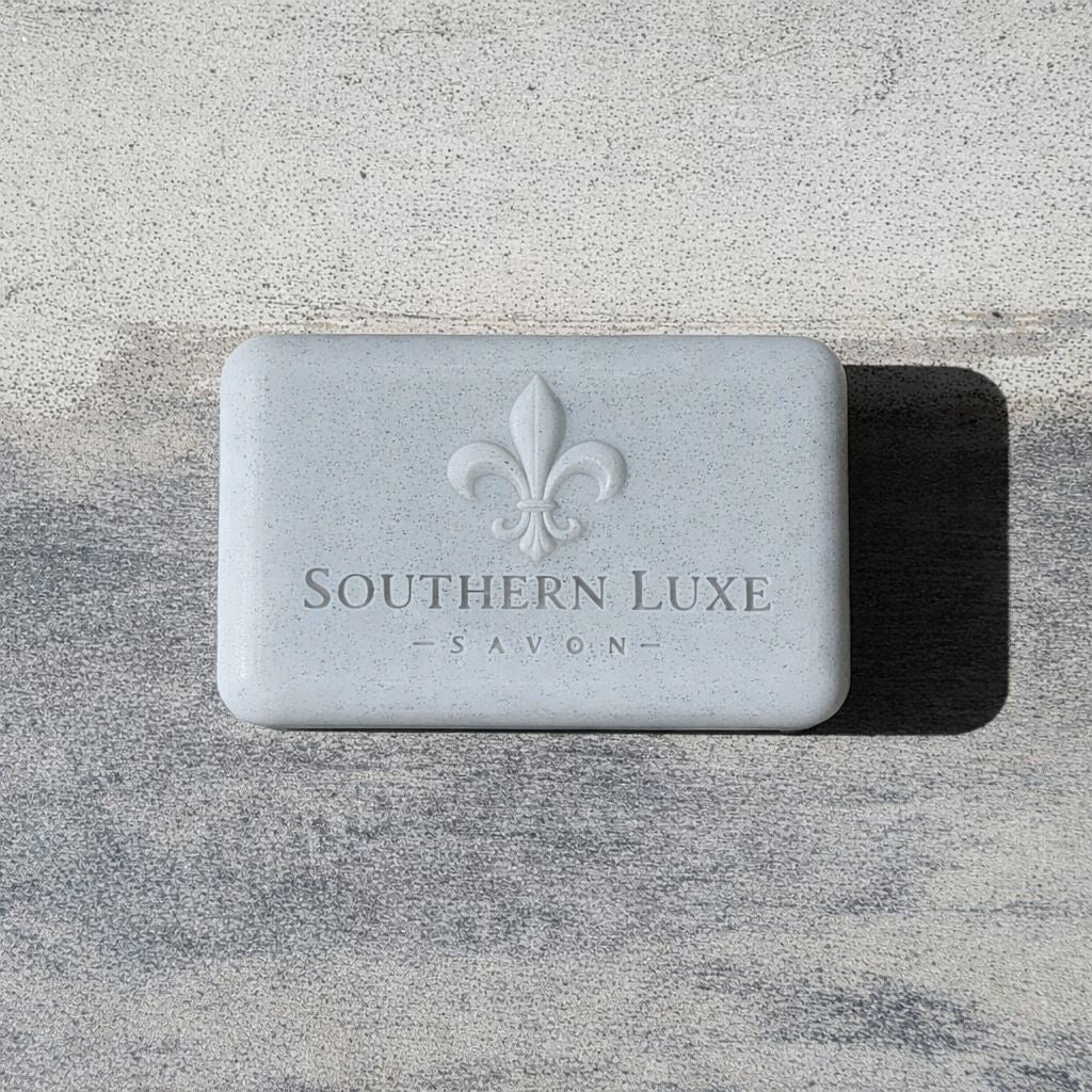 Luxury handmade Cold Stone Creek Bath Bar features activated charcoal, avocado oil, and rich butters with a fresh water scent for a smooth cleanse and lavish lather. Southern Luxe Savon Logo on a large soap bar.