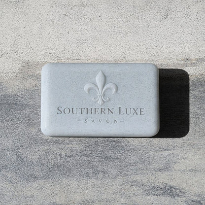Luxury handmade Cold Stone Creek Bath Bar features activated charcoal, avocado oil, and rich butters with a fresh water scent for a smooth cleanse and lavish lather. Southern Luxe Savon Logo on a large soap bar.